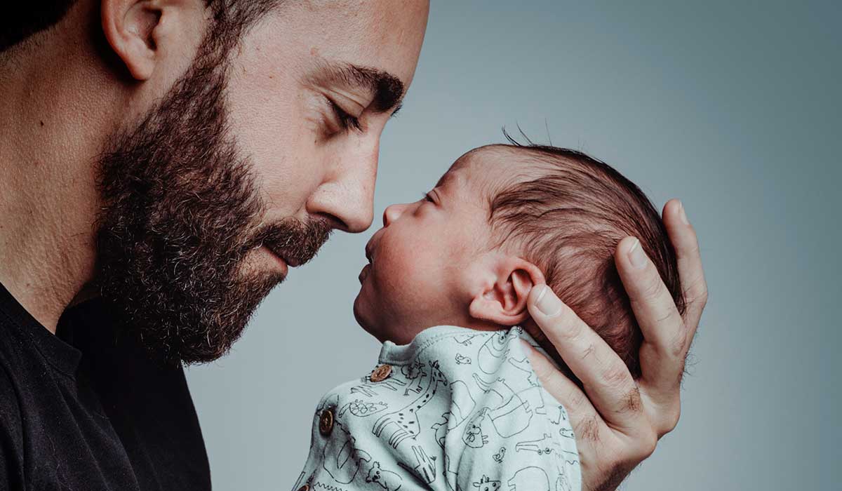 Vater hält sein Neugeborenes liebevoll nah am Gesicht